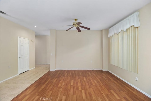 spare room featuring ceiling fan and light hardwood / wood-style flooring