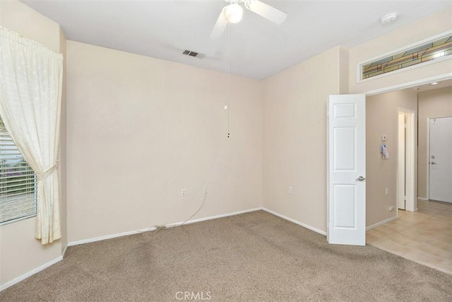 carpeted empty room featuring ceiling fan