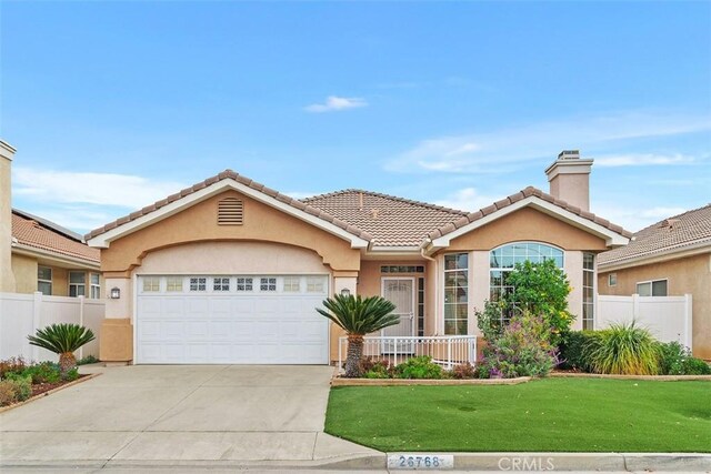 view of front of house with a garage and a front yard