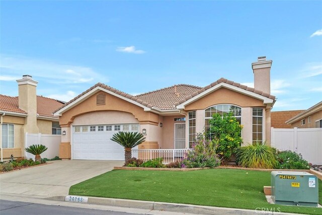 view of front facade with a garage and a front yard