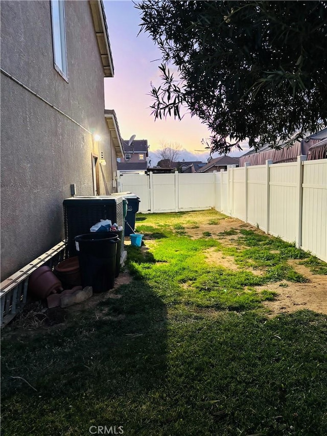 yard at dusk with cooling unit