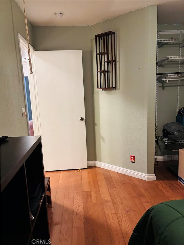 bedroom with hardwood / wood-style floors and a closet