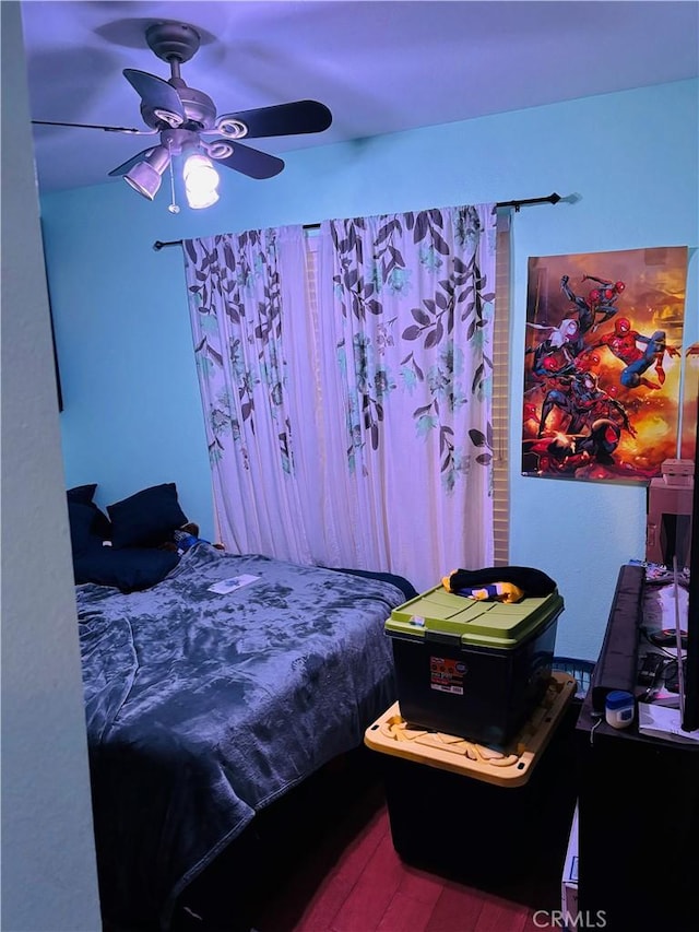 bedroom with ceiling fan and hardwood / wood-style flooring