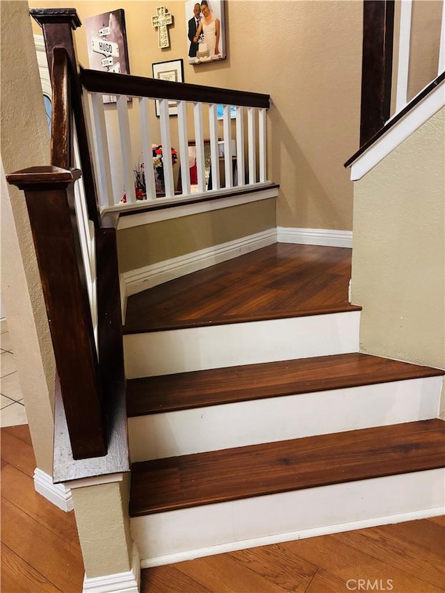 staircase with wood-type flooring