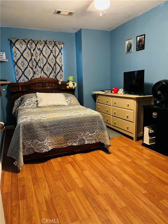 bedroom with light hardwood / wood-style floors