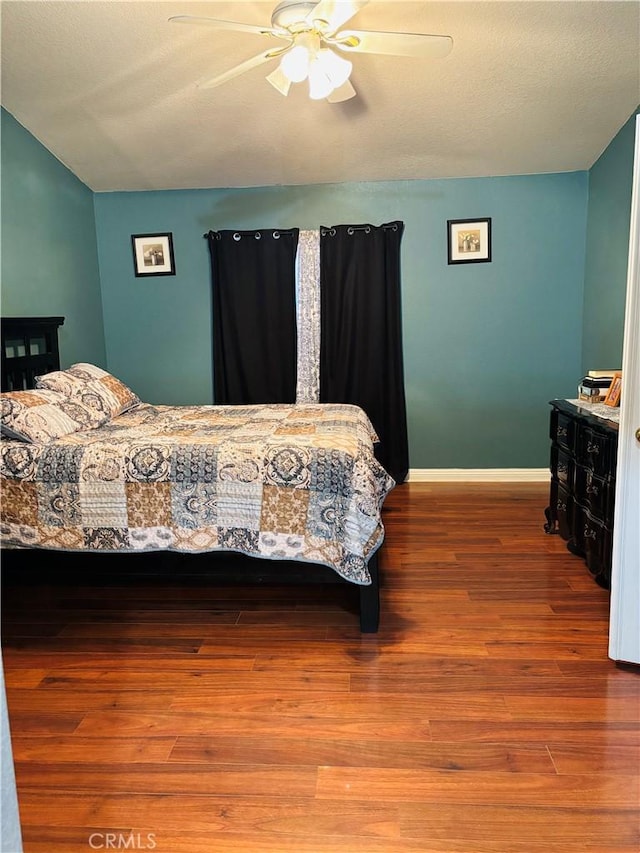 bedroom with ceiling fan and hardwood / wood-style flooring