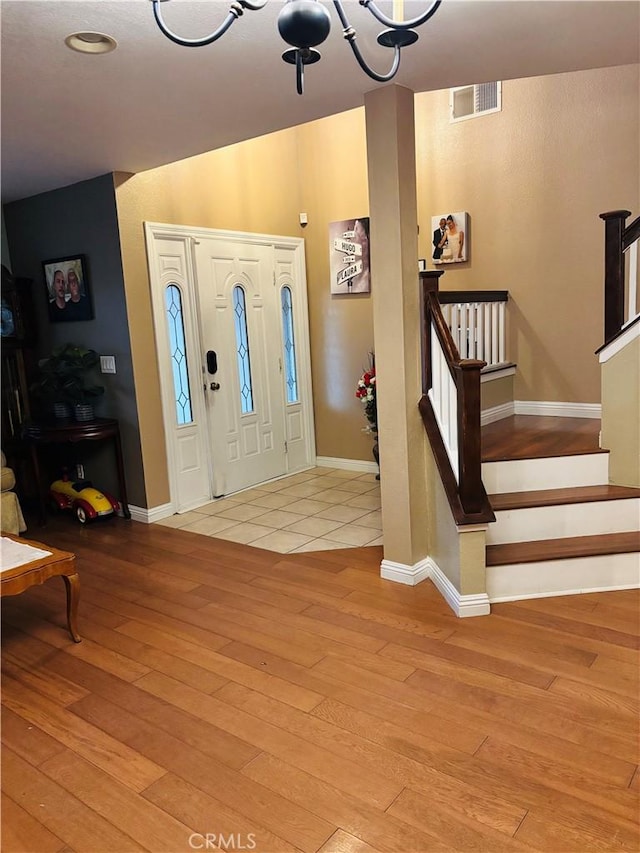 foyer entrance with light hardwood / wood-style floors