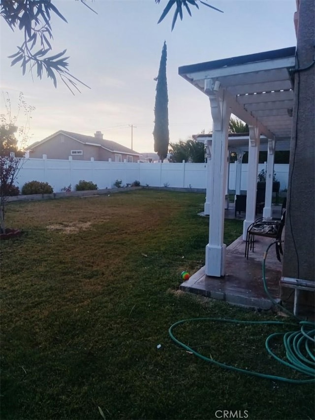 yard at dusk with a pergola