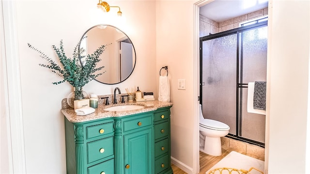 bathroom with vanity, hardwood / wood-style flooring, toilet, and walk in shower