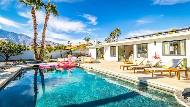 view of pool featuring a mountain view and a patio area