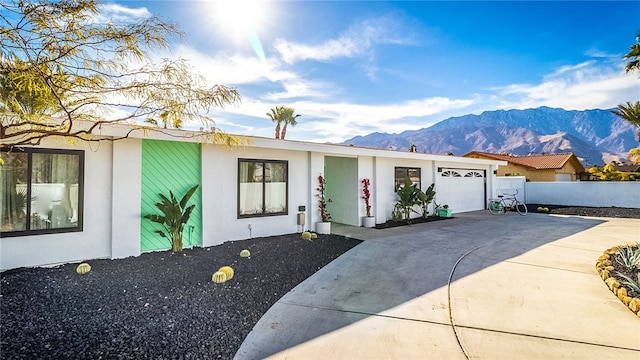 view of front of house with a mountain view and a garage