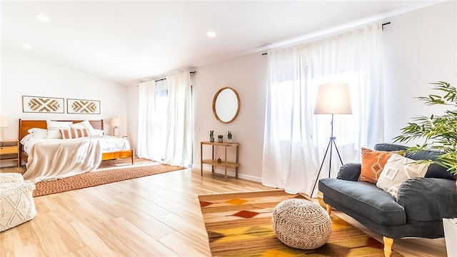 bedroom featuring hardwood / wood-style floors and lofted ceiling