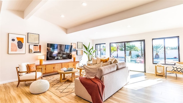 living room featuring lofted ceiling with beams and light hardwood / wood-style floors