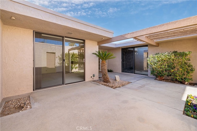 doorway to property with a patio