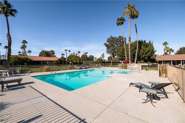 view of swimming pool with a patio area