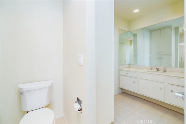 bathroom featuring tile patterned floors, toilet, and vanity