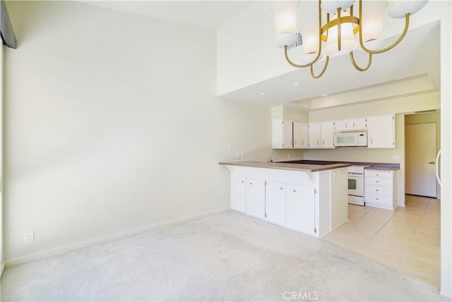 kitchen featuring kitchen peninsula, white appliances, white cabinetry, hanging light fixtures, and a chandelier