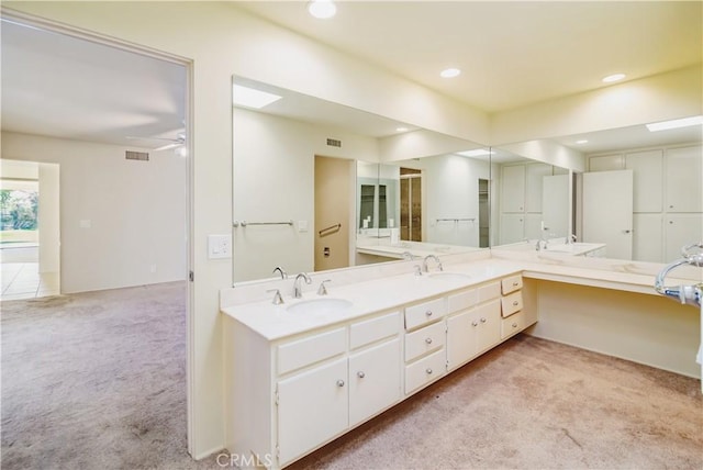 bathroom with ceiling fan and vanity