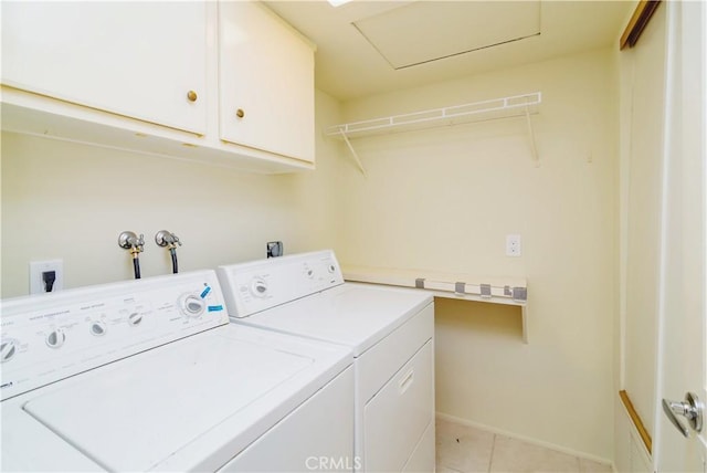 laundry room with cabinets, light tile patterned floors, and independent washer and dryer