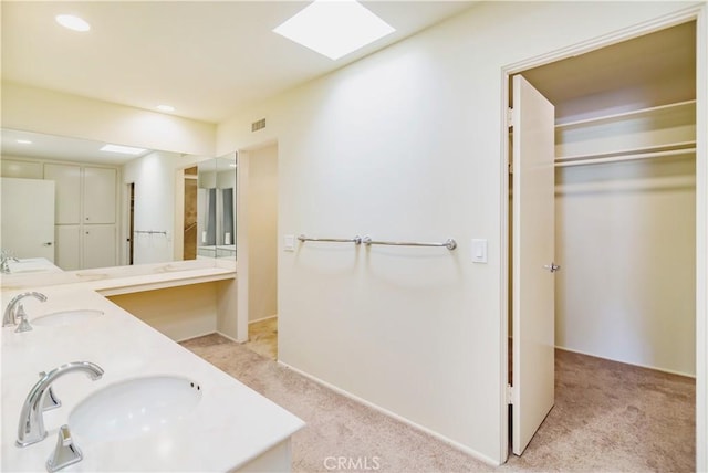 bathroom with vanity and a skylight