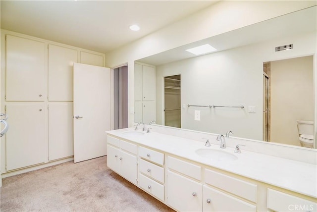 bathroom with toilet and vanity