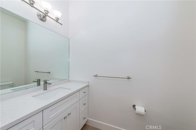 bathroom featuring vanity and toilet