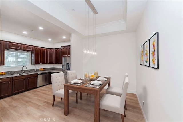 kitchen with stainless steel appliances, light hardwood / wood-style flooring, crown molding, pendant lighting, and dark brown cabinets