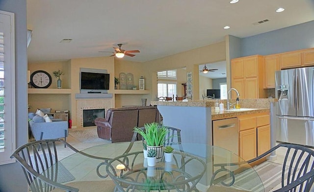 dining room featuring ceiling fan, light tile patterned floors, and sink