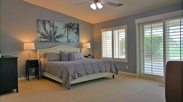 bedroom featuring light carpet, vaulted ceiling, and ceiling fan