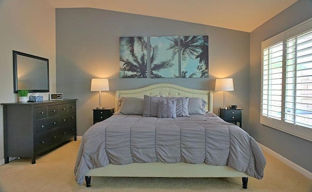 carpeted bedroom featuring lofted ceiling