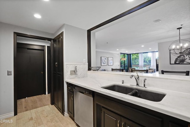 kitchen with light wood-type flooring, stainless steel dishwasher, dark brown cabinets, sink, and an inviting chandelier