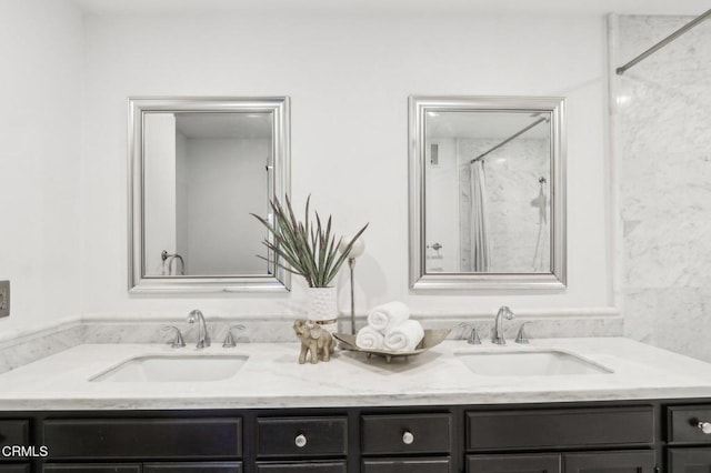 bathroom featuring tiled shower and vanity