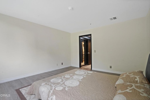 bedroom with hardwood / wood-style floors