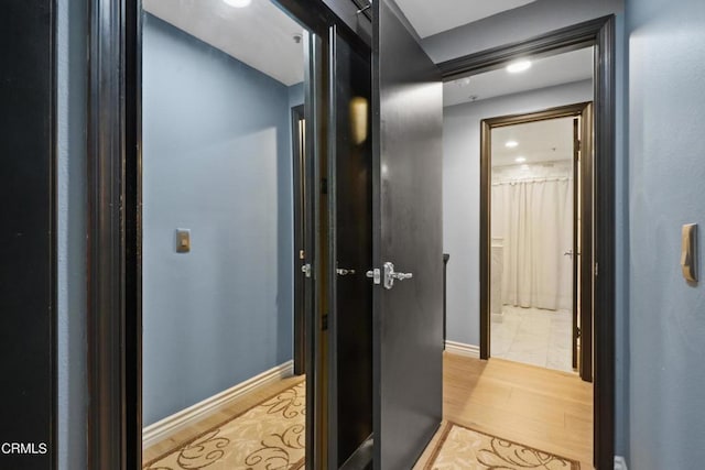 hallway with light wood-type flooring