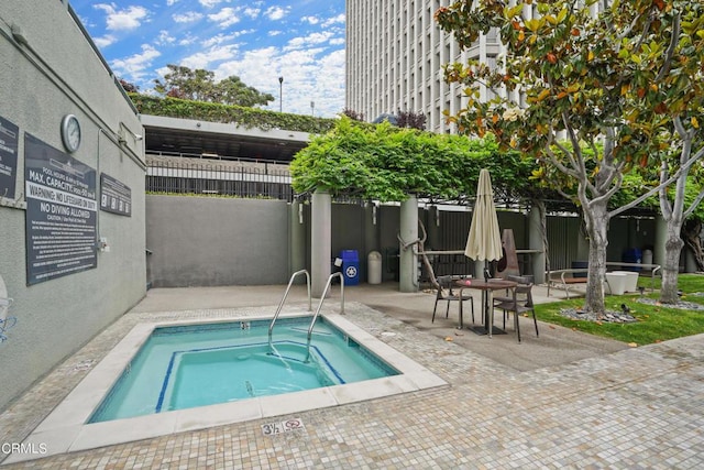 view of pool with a patio area and a hot tub