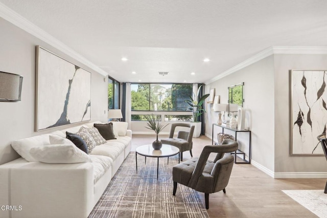 living room featuring light hardwood / wood-style flooring, expansive windows, and ornamental molding