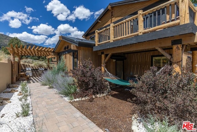 view of home's exterior with a pergola