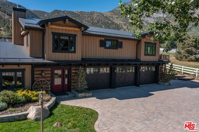 view of front of home featuring a mountain view and a garage