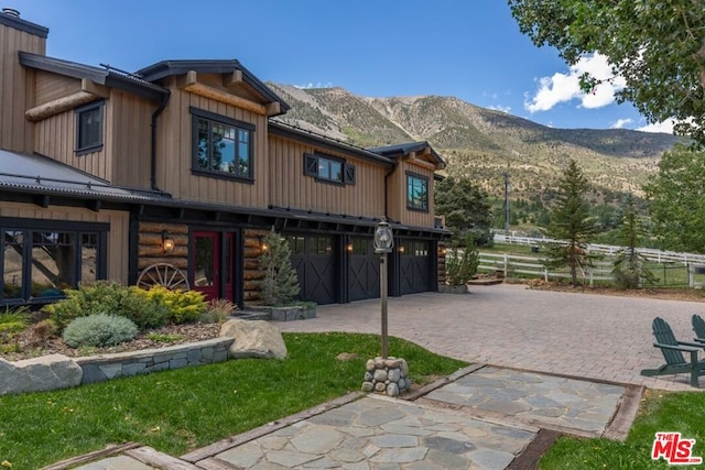 view of front facade featuring a mountain view and a garage