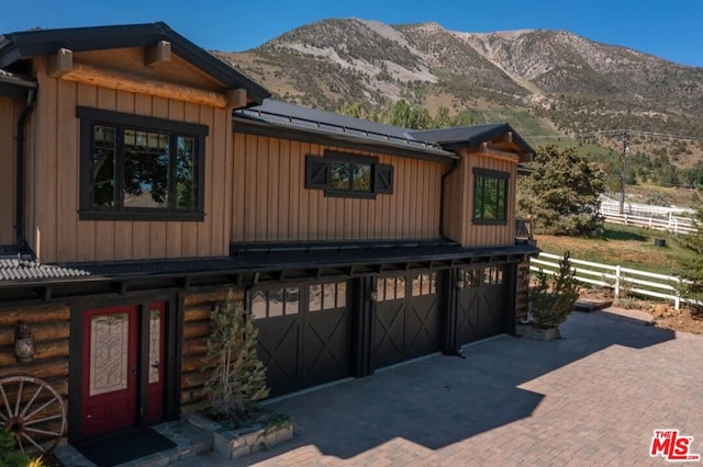 exterior space with a mountain view and a garage