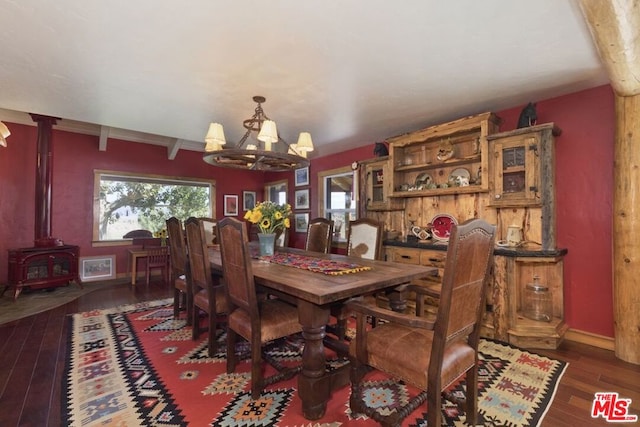 dining space with a chandelier, dark hardwood / wood-style flooring, and a wood stove