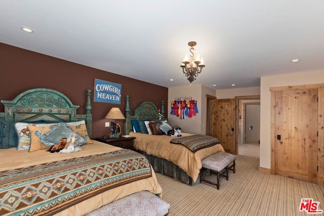 carpeted bedroom featuring an inviting chandelier