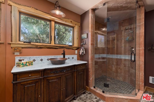 bathroom with vanity and a shower with door