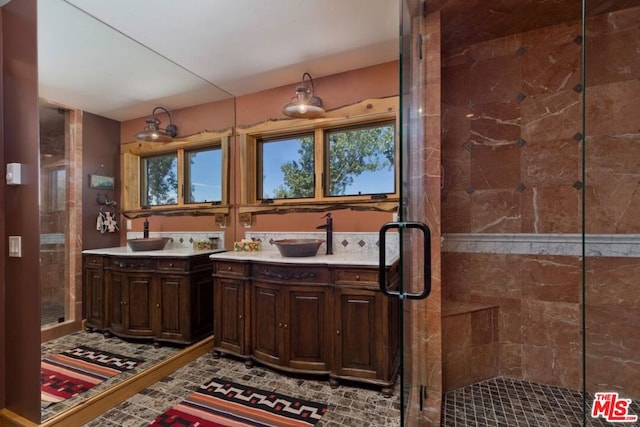 bathroom featuring vanity and a shower with door