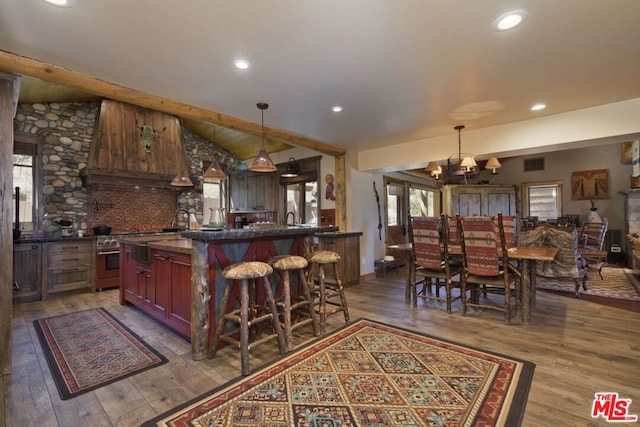 kitchen featuring a chandelier, wood-type flooring, vaulted ceiling with beams, and decorative light fixtures