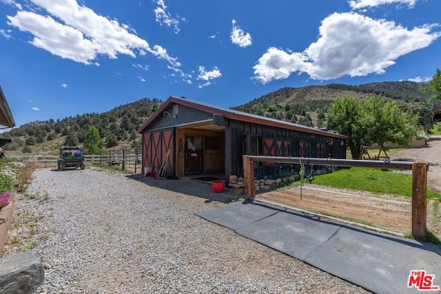 view of stable with a mountain view