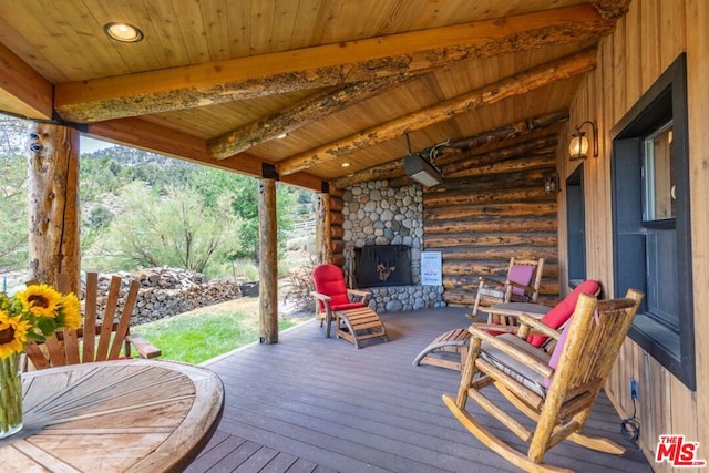 deck featuring an outdoor stone fireplace