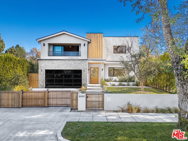 modern home featuring a garage and a balcony