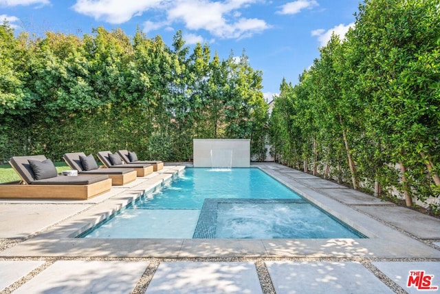 view of swimming pool with pool water feature and a patio area