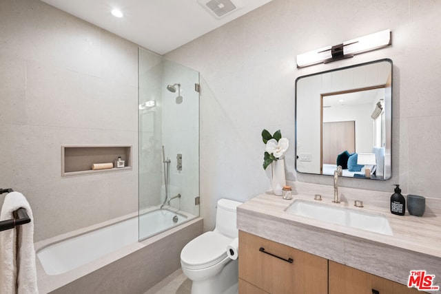 full bathroom featuring vanity, toilet, and tiled shower / bath combo